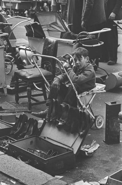  A boy is pictured sitting on a push chair in a black and white snap taken during the 1950s