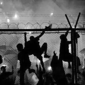  Barra Bravas yobs scale a fence to attack rivals at a game in Argentina