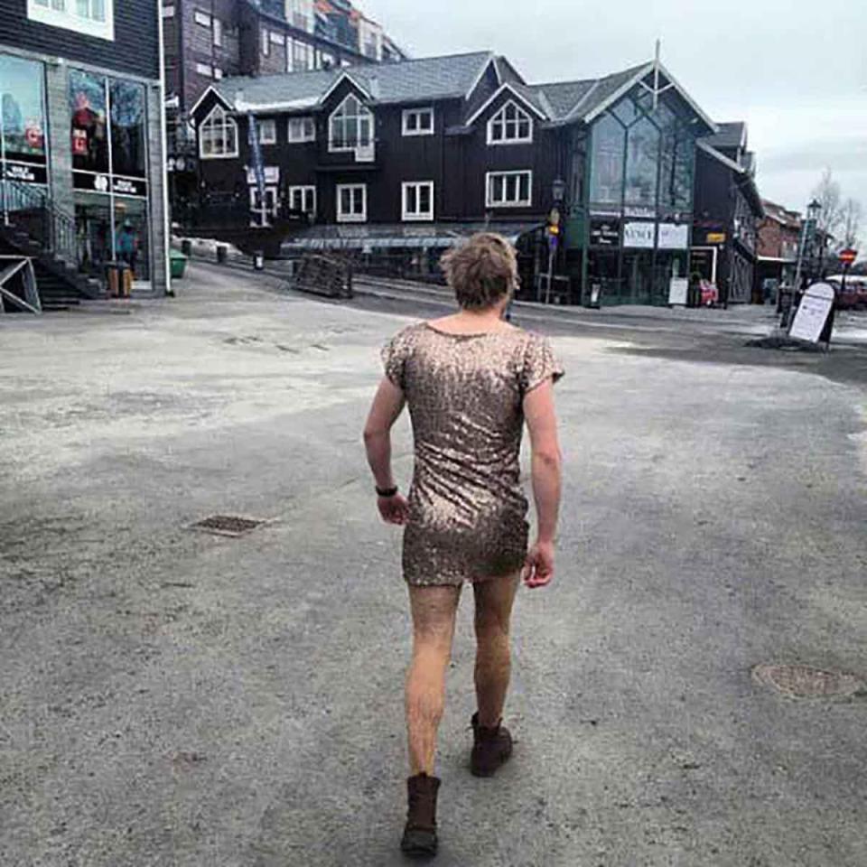  One man braves the walk home in a glittery gold dress and boots