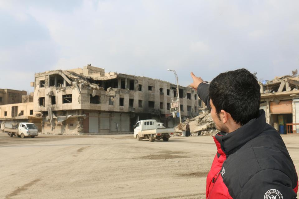  Local shopkeeper Barzan points to a roof which ISIS would throw alleged homosexuals from