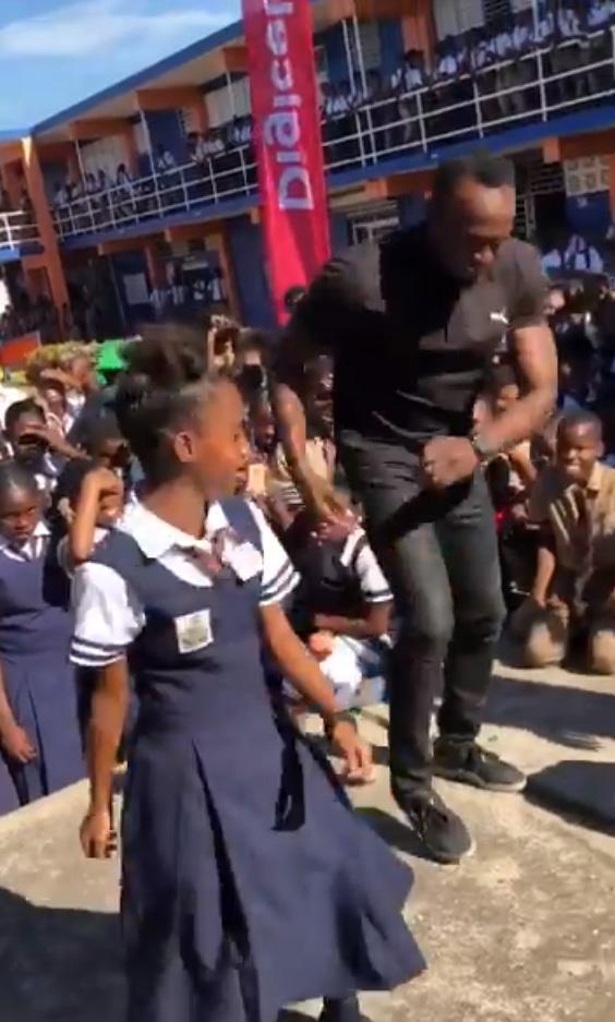 Usain Bolt engaged in a dance-off on a visit to a school in Kingston