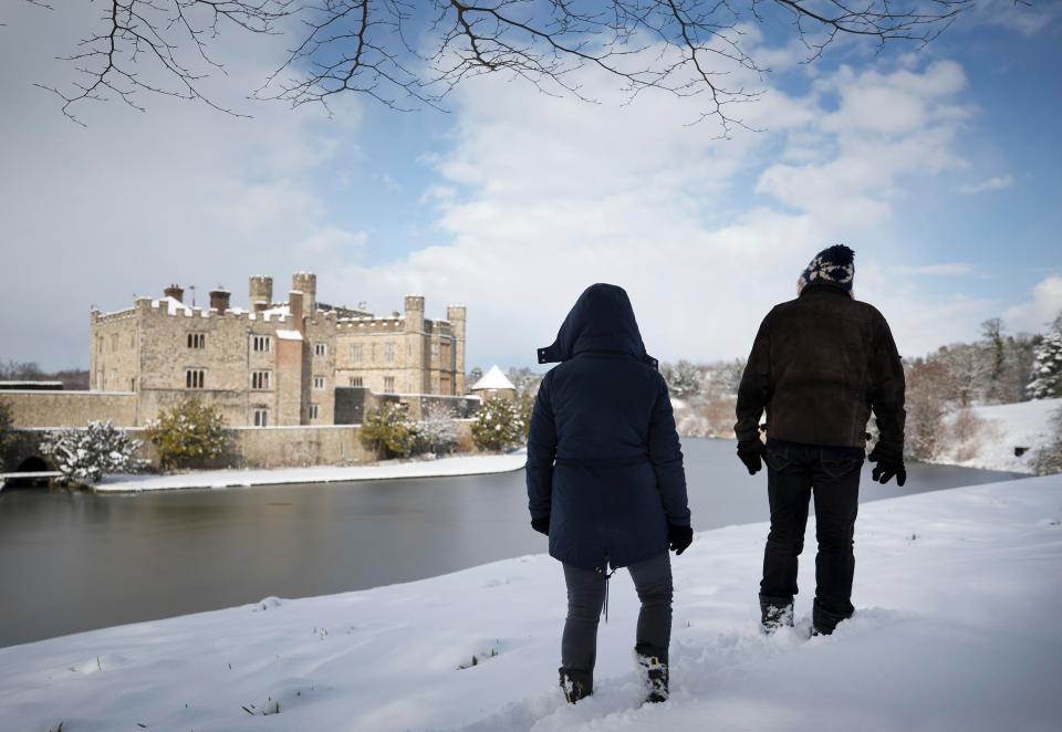  Walkers pass Leeds Castle after it was closed following heavy snow in the area