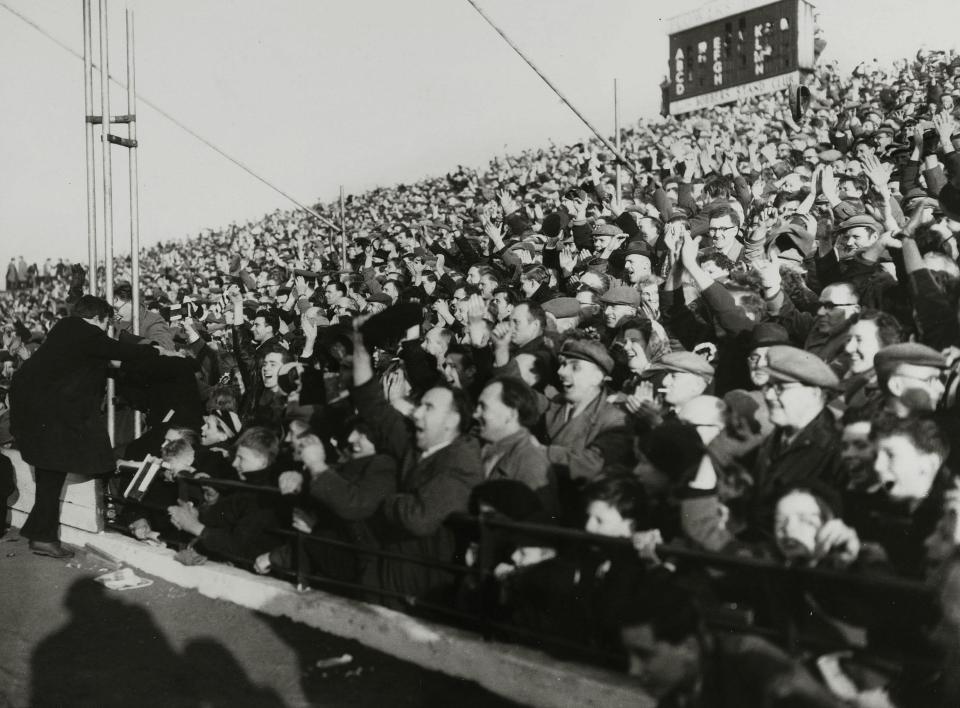  Football fans wore flat caps and suits to cheer on their teams in the 50s