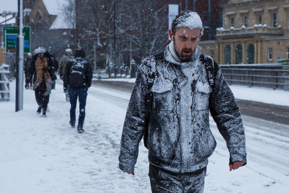  A man trudges through the early morning snow in Leeds, West Yorkshire