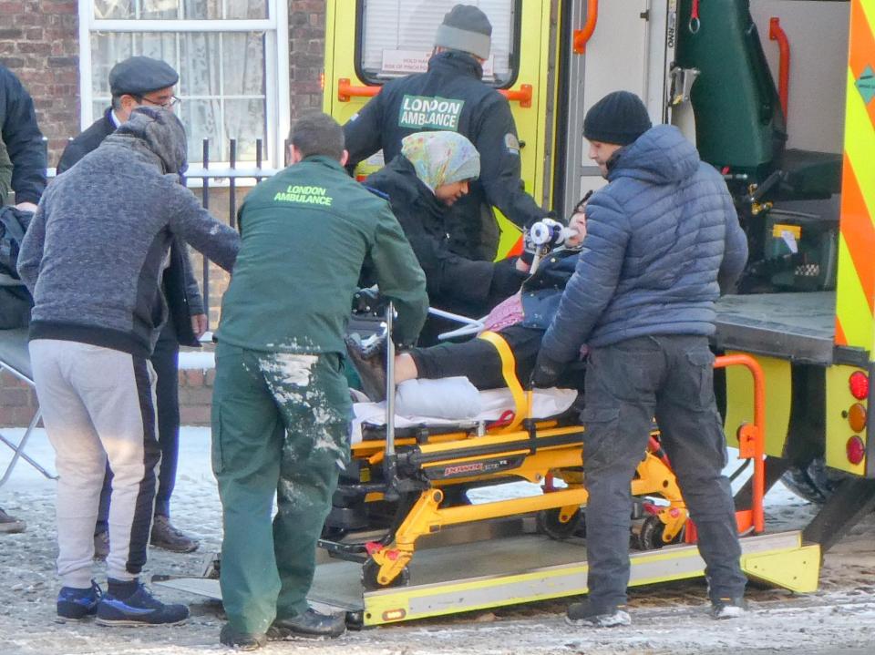  Emergency services help an elderly lady who broke her leg after slipping in the snow this morning in Hackney