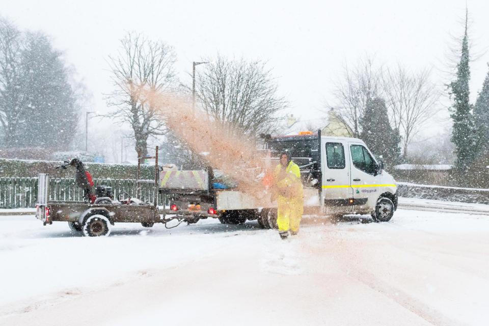  Council workers in Stirlingshire spread grit outside a doctor's surgery in Killearn, Scotland