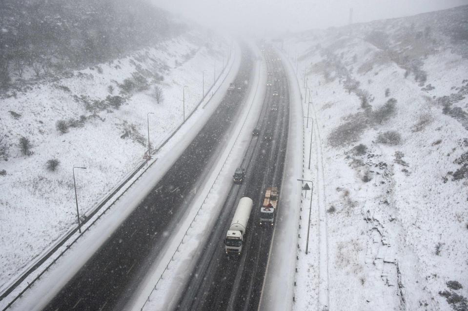  Vehicles negotiate the M62 motorway during a heavy snow shower near the village of Ripponden, northern England