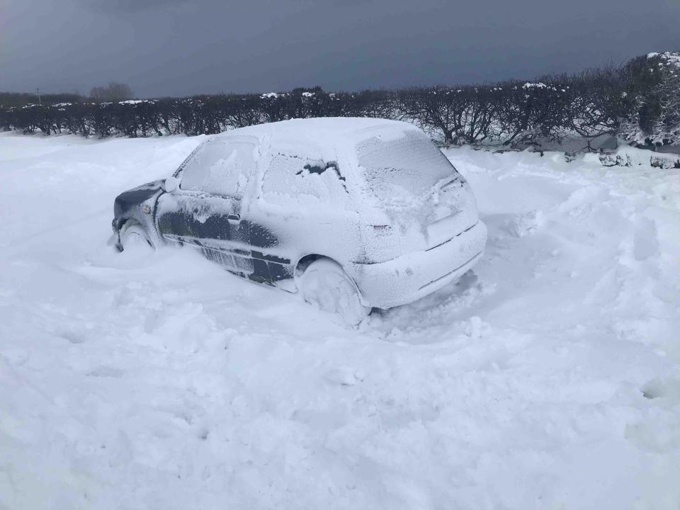  This abandoned car got stuck in a snow drift at 6am as heavy snow fell across Greatham High Street in Teesside