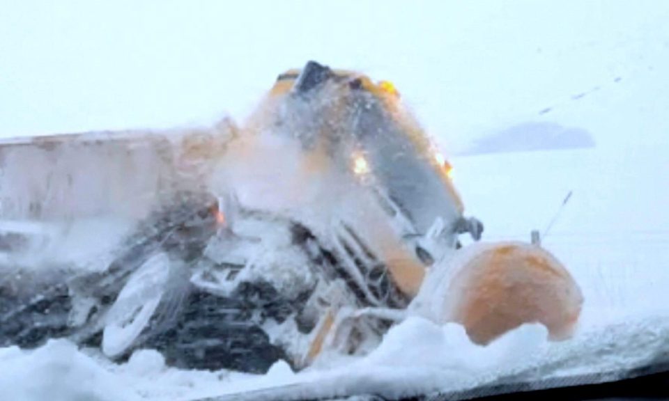  A snow gritter lies on its side on the A68 leading from Tow Law towards Consett in County Durham