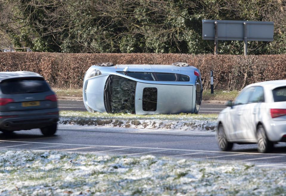  A car lies on it's side on the A24 after turning over in icy conditions near Leatherhead