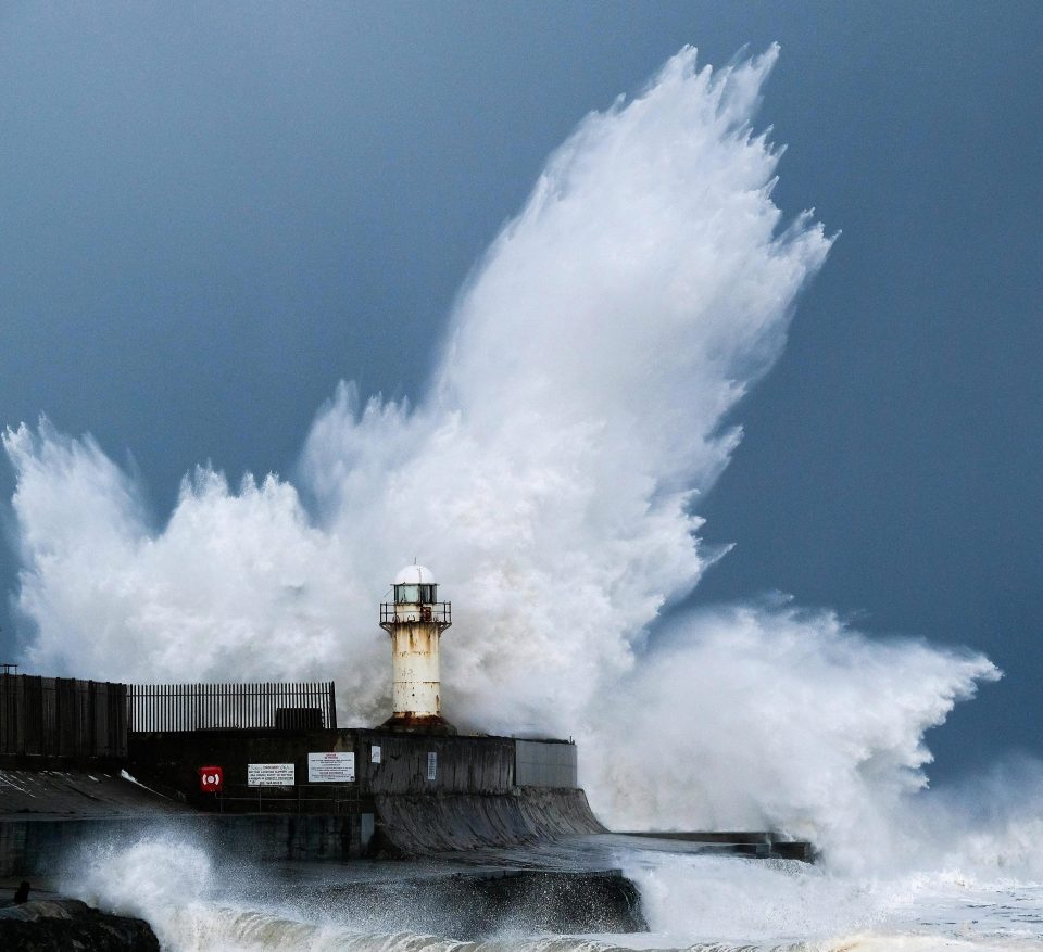  Huge waves break against the sea wall and lighthouse at the mouth of the River Tees