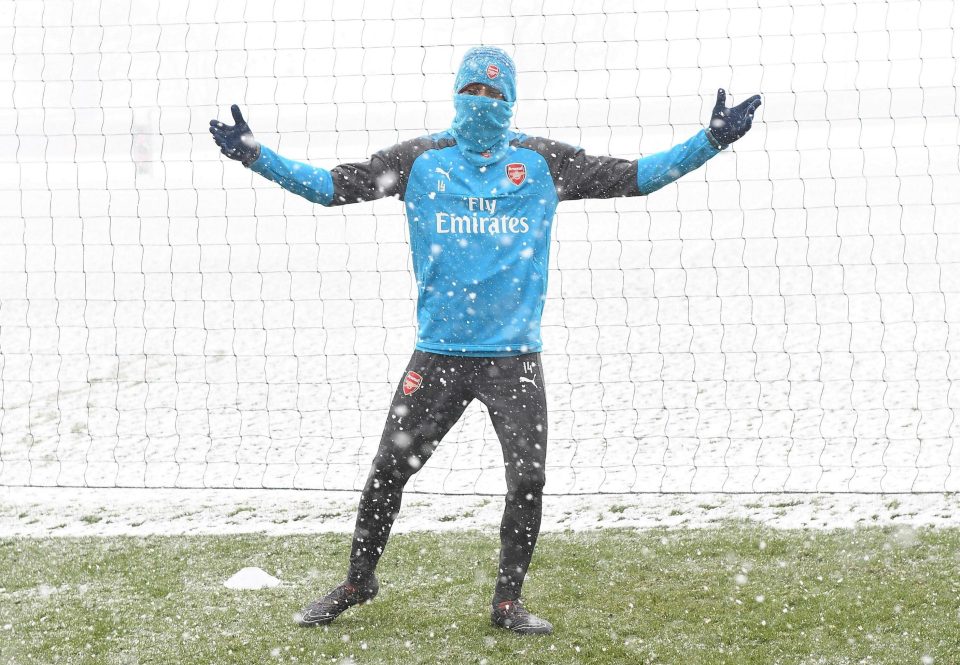  Pierre-Emerick Aubameyang wraps up with snow falling down at London Colney