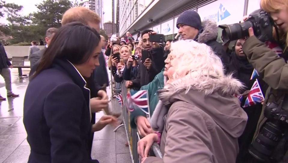  Prince Harry and Meghan Markle stop to talk to two ladies in the crowd