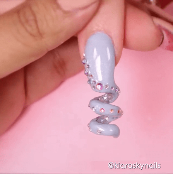 The end result of the video showed the rhinestone encrusted nail