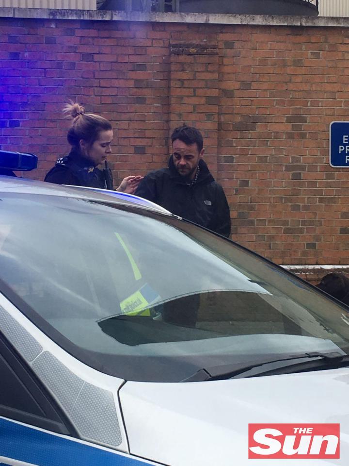  Ant McPartlin is seen being spoken to by a police officer at the scene of the crash