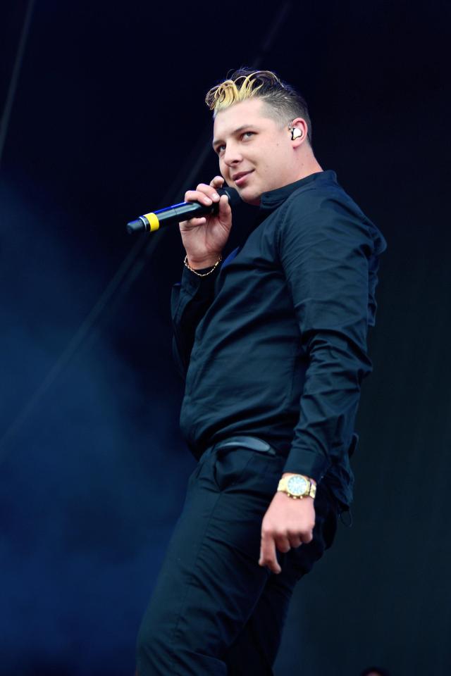 John Newman on stage with mic