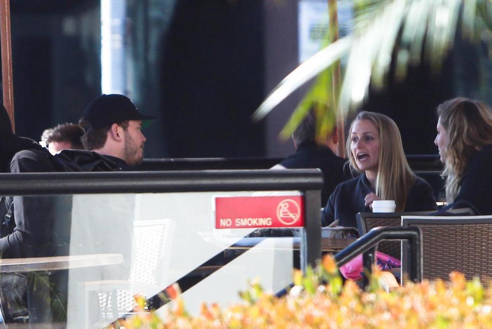  Chris and the blonde woman were engrossed in conversation as they met up for coffee this week