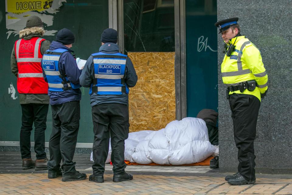  A shot from Blackpool shows a rough sleeper being helped by social workers to get out of the cold