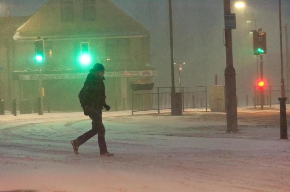  Members of the public ditch their cars to walk across icy roads in Brynmawr, Blaenau Gwent, South Wales