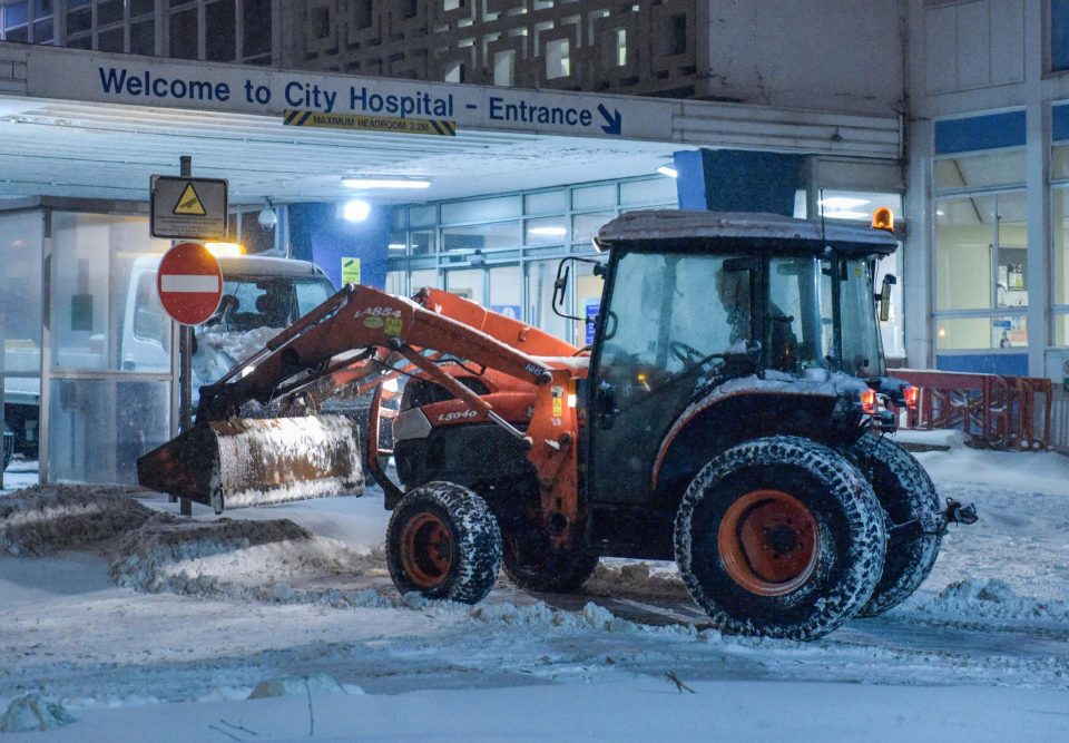  A tractordriver helps to keep the roads clear at City Hospital in Birmingham