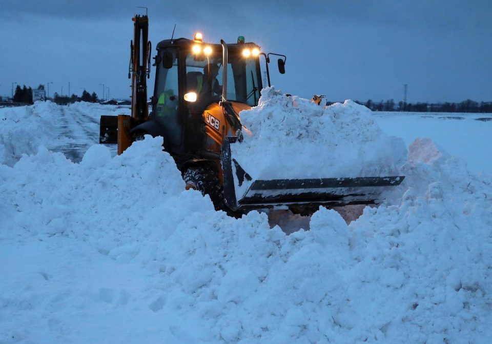  A digger works into the evening to clear snow from the A905 near Skinflats, Falkirk