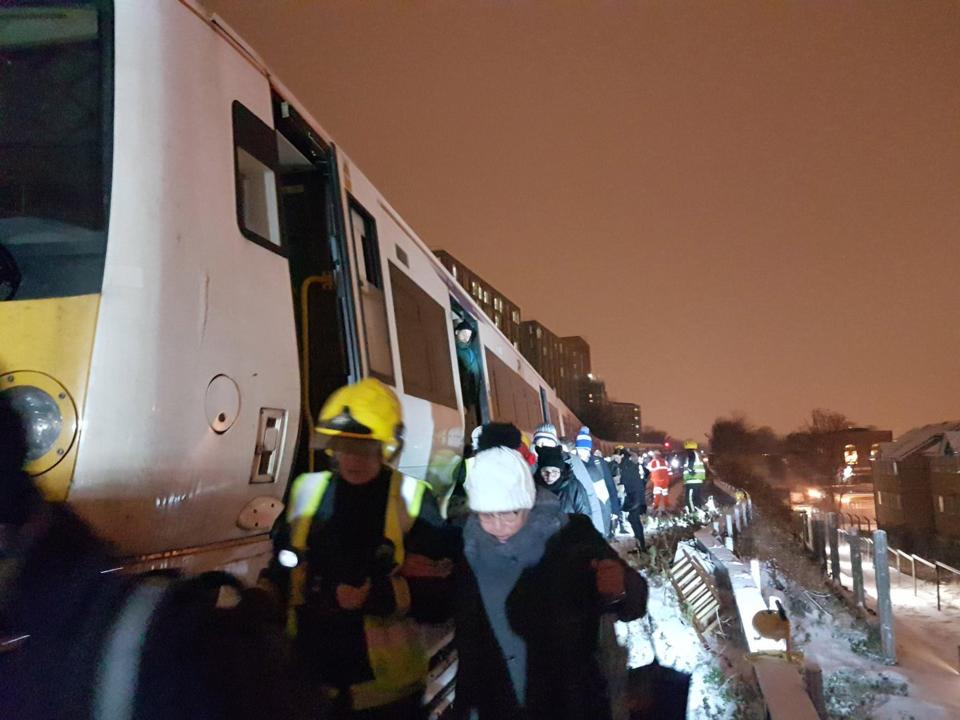  Emergency crews arrive to rescue those on the trains and walking along tracks