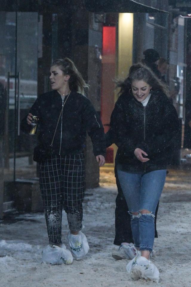 These girls wear Morrisons bags to protect their shoes in Birmingham