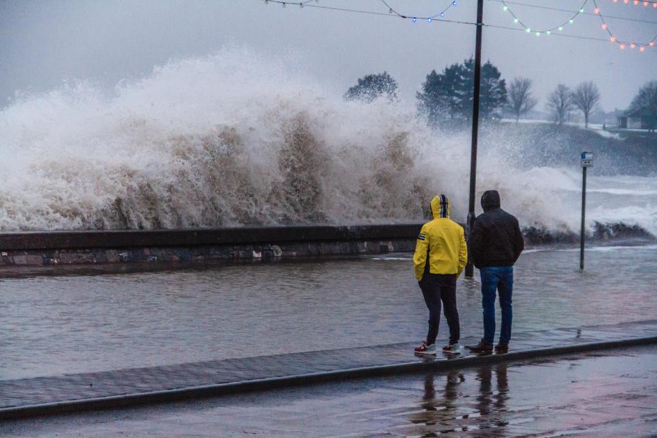  Two locals watch on as conditions intensify in Devon