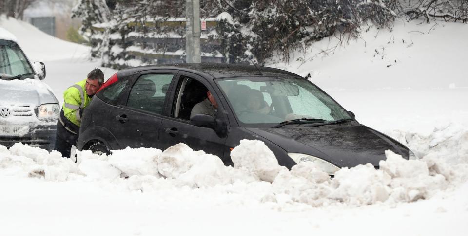  A man gives a motorists in Dublin a helping hand