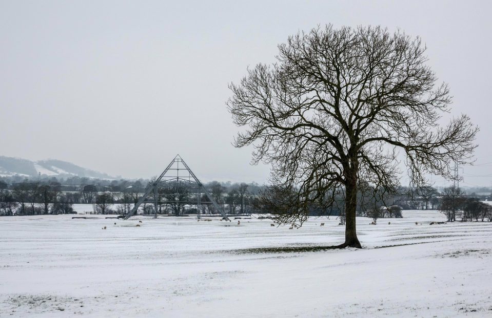 Snow surrounds the skeleton structure of the Pyramid Stage at the site of the Glastonbury Festival site at Worthy Farm in Pilton near Glastonbury