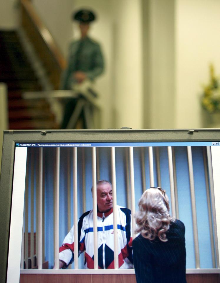 2006 file picture Sergei Skripal speaks to his lawyer from behind bars seen on a screen of a monitor outside a courtroom in Moscow