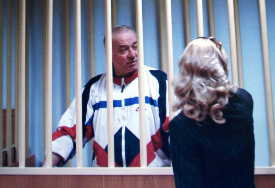  Sergei Skripal speaks to his lawyer from behind bars in a courtroom in Moscow