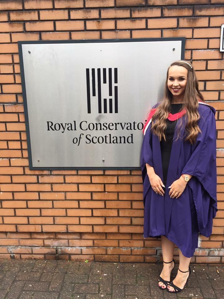 Caitlin on her graduation day after earning a teaching degree