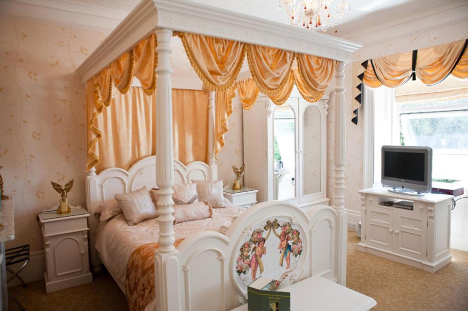  The romantic theme, which features a cherub design on the end of the bed, extends across the property