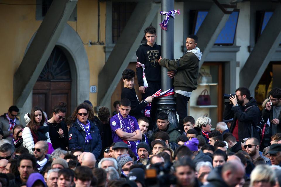 Fans hugged lamp posts to get a better view of the coffin arriving at the Basilica