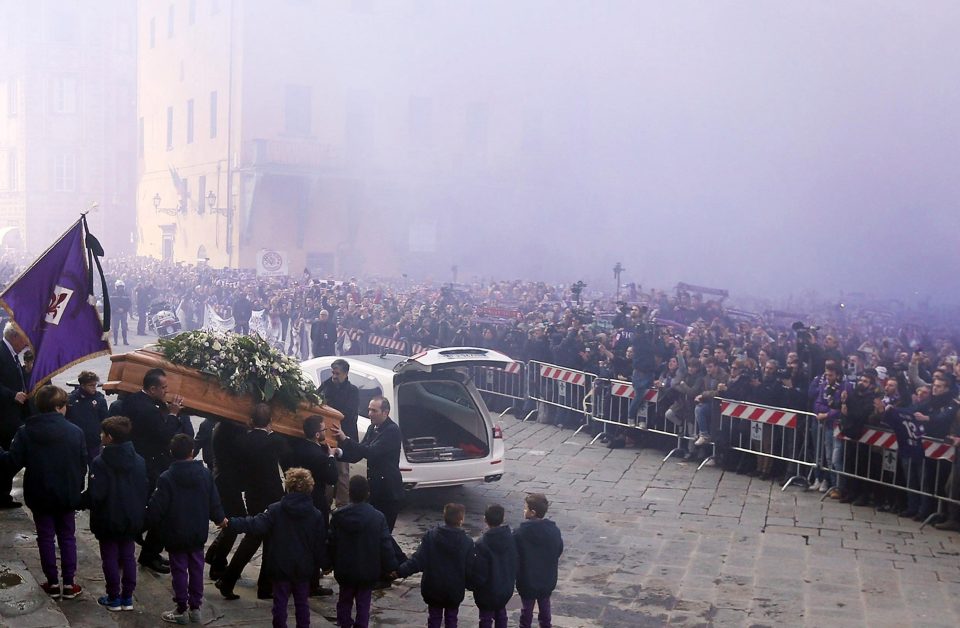 Astori's coffin is taken down to a white hearse after the funeral service