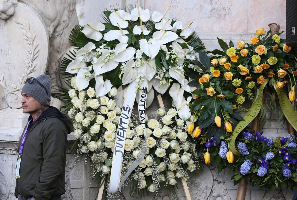 A vibrant flower display is put out for the ceremony with flowers from rival clubs