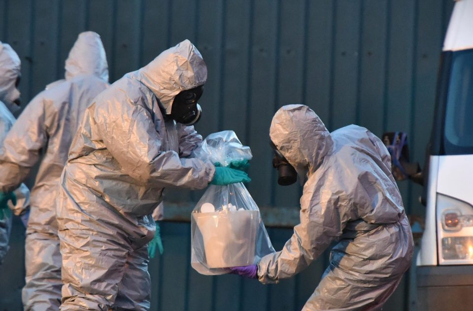 Forensic police officers wearing hazmat suits prepare to examine a vehicle believed to belong to Sergei Skripal 