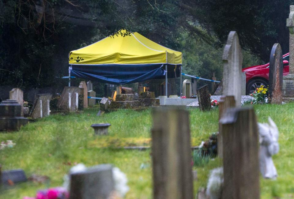  Officers in hazard suits place a tent over the grave of poisoned double agent Sergei Skripal's son