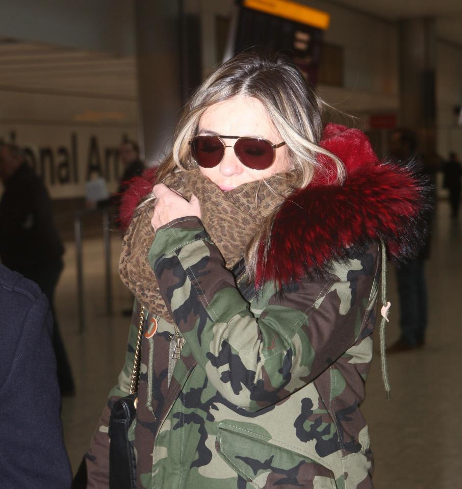  Liz wrapped up for the cold weather yesterday as she was seen arriving back in London