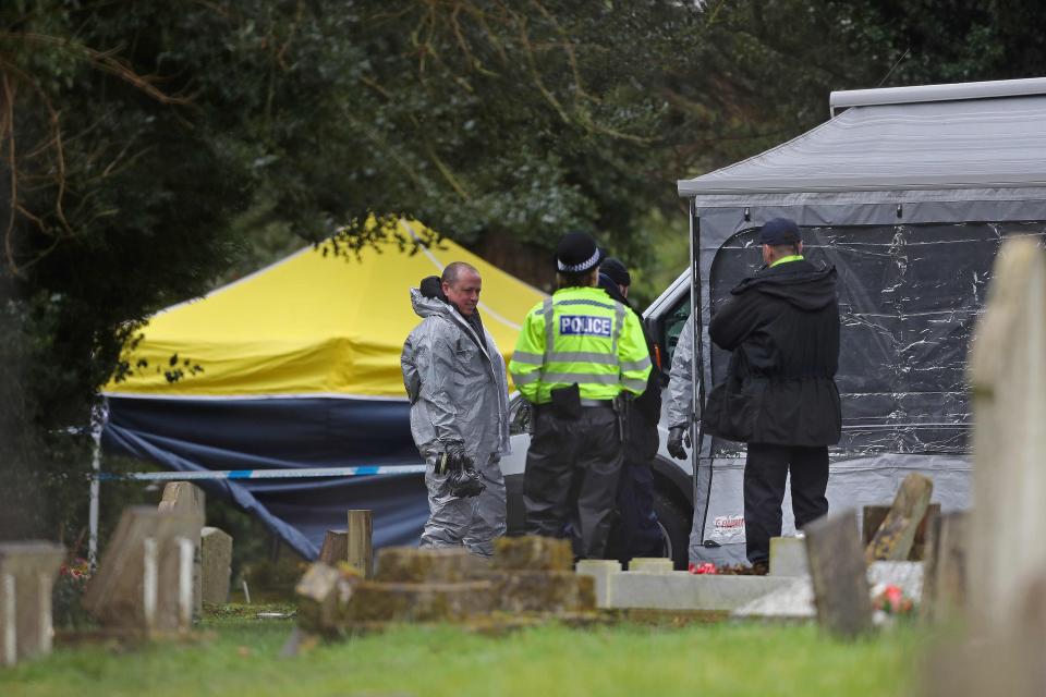  Members of the emergency services, one in a biohazard suit, work at the London Road Cemetery in Salisbury