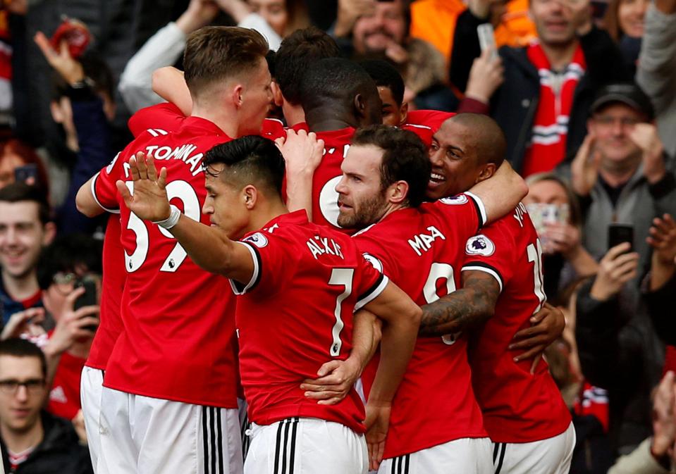  The United players huddle around their two-goal scorer as Liverpool were put to the sword