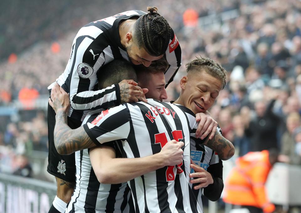  Kenedy celebrates with his team-mates after scoring his second of the match