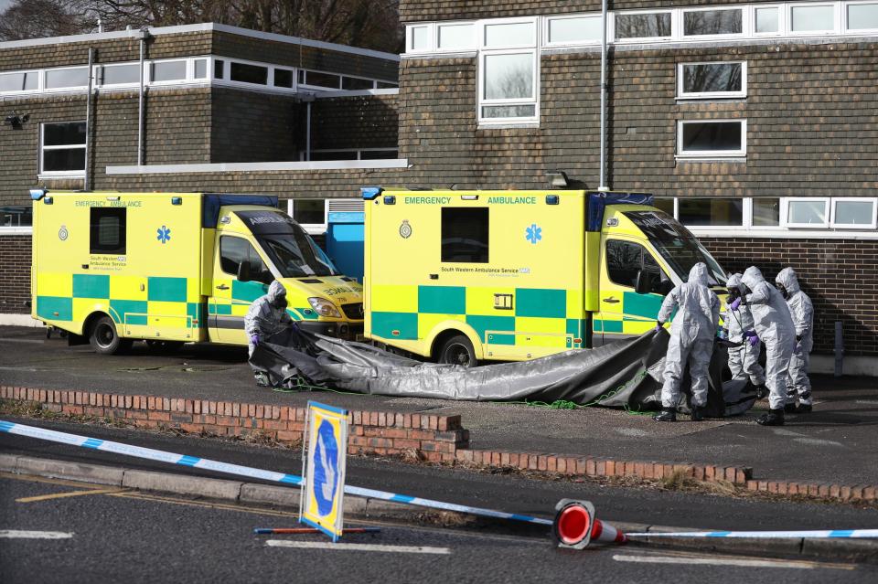  Investigators in gas masks examine an ambulance at the South Western Ambulance Service station in Harnham, near Salisbury