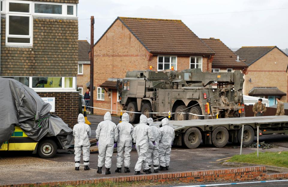  Soldiers in protective suits load an ambulance wrapped in a tarpaulin on to a truck at an ambulance station in Salisbury. Residents have described the area as a 'disaster movie'