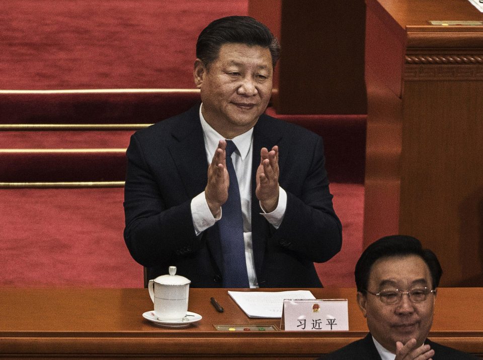  China's President Xi Jinping applauds after a vote in Beijing