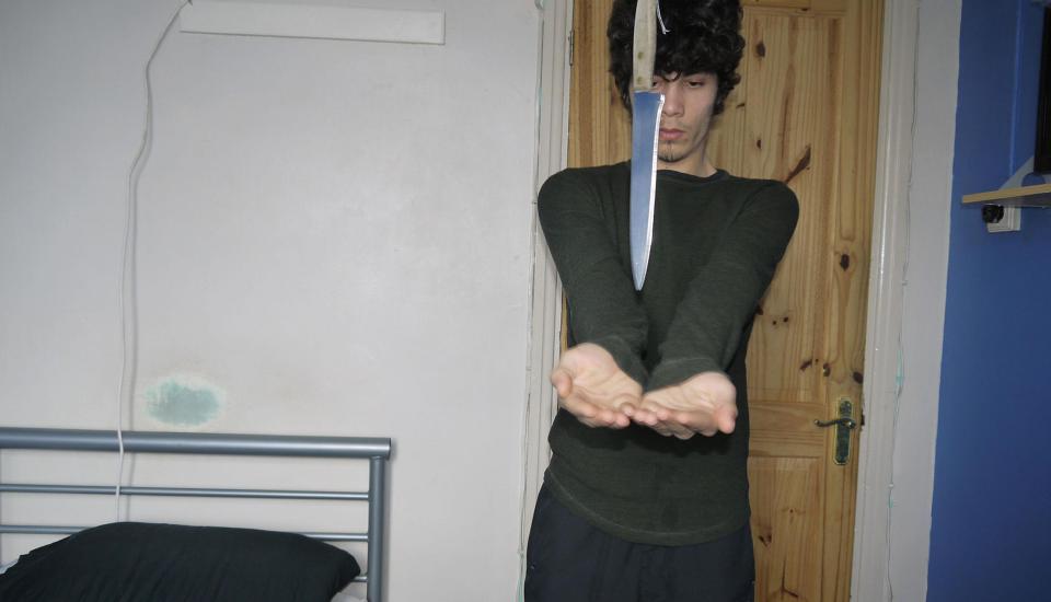  Hassan is shown with a large knife in a photo taken at his home in Sunbury, Surrey