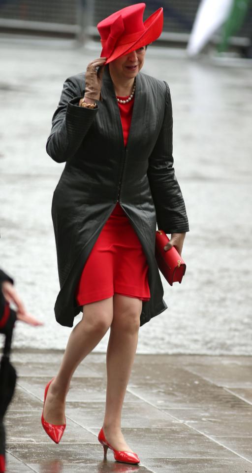  The Prime Minister had to hold her hat while she walked into the event