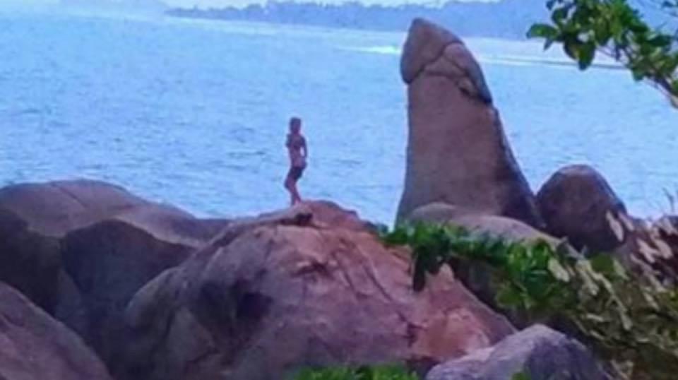  The mystery blonde was pictured stripping next to the mythical rock