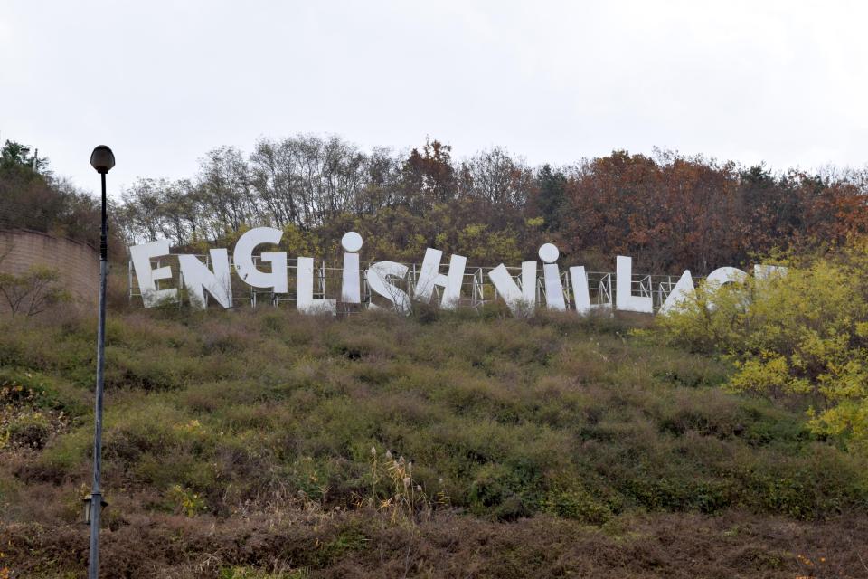  A sign welcomes visitors to the 'English Village'